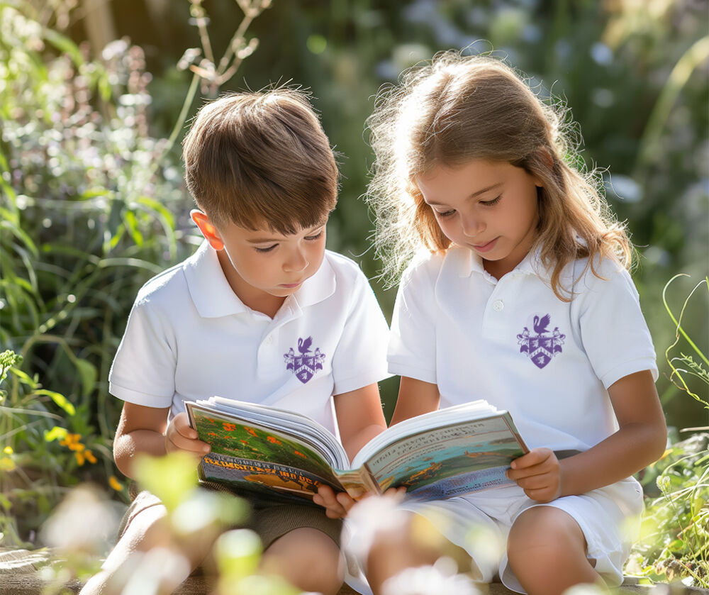 students readin book outdoors